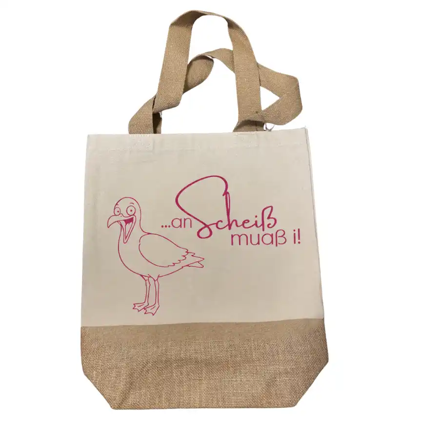 Robuste Einkaufstasche mit Jute-Applikation und frechem Dialekt-Spruch „an Scheiß muaß i“ mit kackender Möwe. | werktraum33